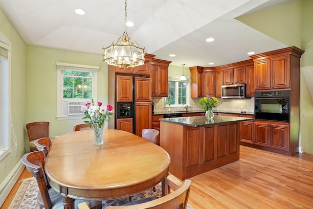 41 White Birch Dr, Trumbull, CT 06611 - kitchen featuring oven, stainless steel microwave, paneled refrigerator, light wood-type flooring, and healthy amount of natural light