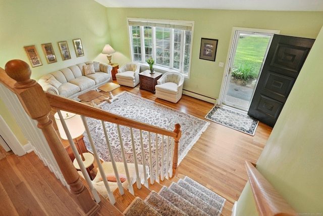 41 White Birch Dr, Trumbull, CT 06611 - living room with a baseboard heating unit, plenty of natural light, wood finished floors, and stairs
