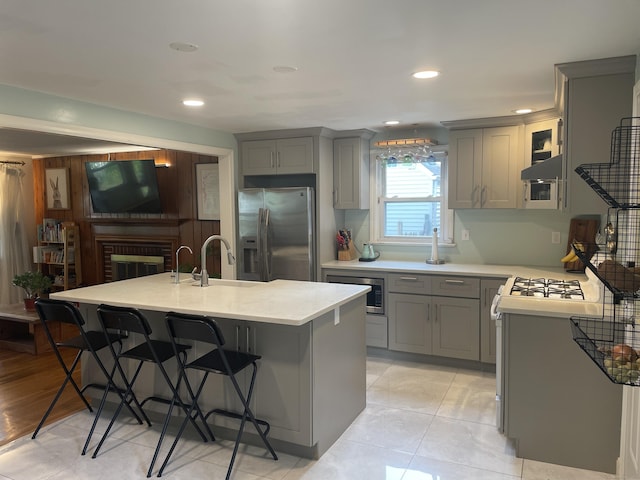 41 Baxter Dr, Norwalk, CT 06854 - kitchen with stainless steel appliances, gray cabinetry, a kitchen bar, light countertops, and recessed lighting