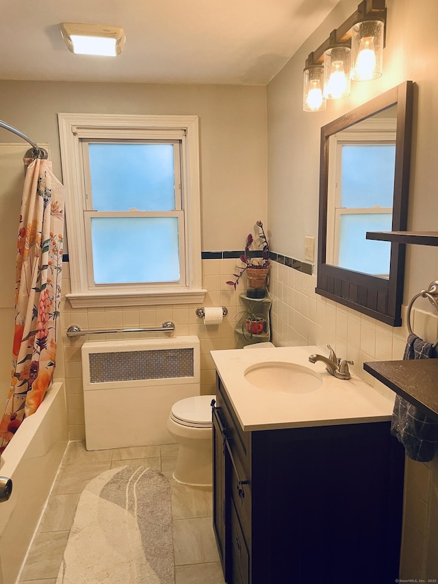 41 Baxter Dr, Norwalk, CT 06854 - bathroom featuring radiator heating unit, vanity, tile walls, shower / bath combo with shower curtain, and tile patterned flooring
