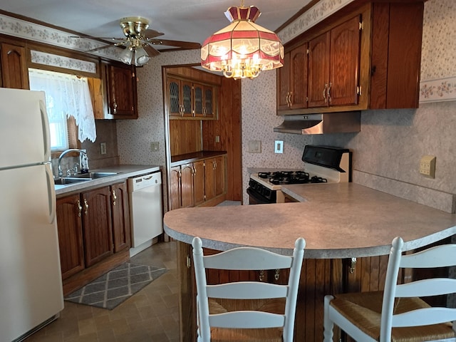 65 Woodland Park, Shelton, CT 06484 - kitchen featuring white appliances, exhaust hood, a peninsula, wallpapered walls, and pendant lighting