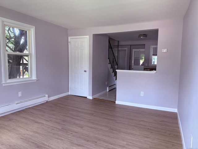 49 Soundview Ave Unit 49, Stamford, CT 06606 - empty room with stairs, baseboard heating, healthy amount of natural light, and wood finished floors