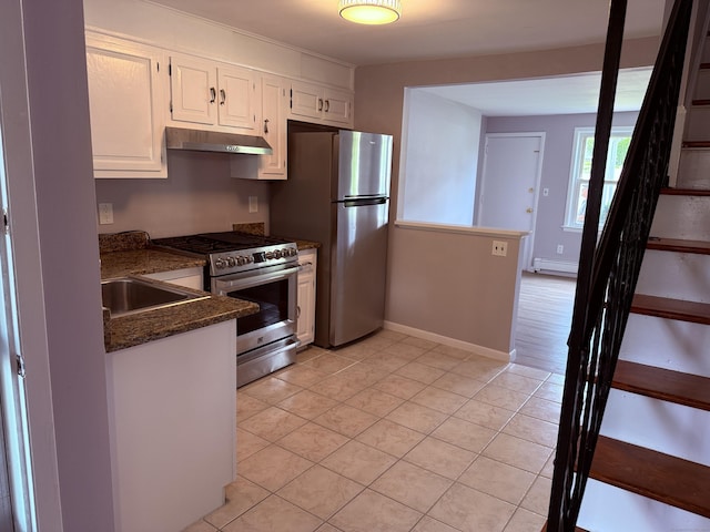 49 Soundview Ave Unit 49, Stamford, CT 06606 - kitchen with stainless steel appliances, under cabinet range hood, white cabinets, light tile patterned floors, and dark stone countertops