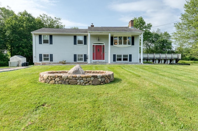 28 Clementel Dr, Durham, CT 06422 - bi-level home featuring a front yard, a chimney, and an outdoor structure