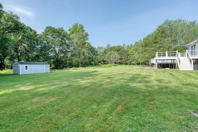 28 Clementel Dr, Durham, CT 06422 - view of grassy yard with a wooden deck, stairway, and a storage shed