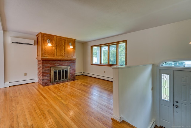 28 Clementel Dr, Durham, CT 06422 - entryway featuring baseboard heating, a wall unit AC, light wood-type flooring, and a fireplace