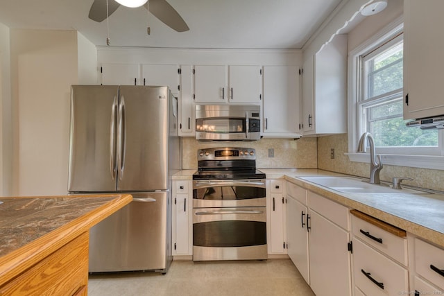 28 Clementel Dr, Durham, CT 06422 - kitchen with stainless steel appliances, light countertops, white cabinets, ceiling fan, and backsplash