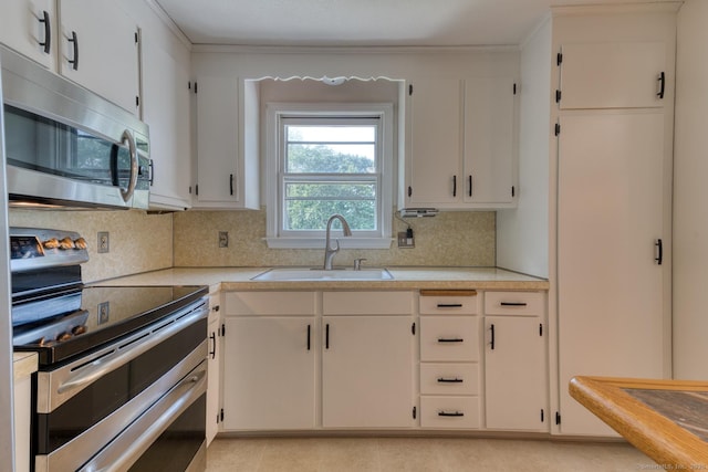 28 Clementel Dr, Durham, CT 06422 - kitchen with appliances with stainless steel finishes, light countertops, decorative backsplash, white cabinets, and crown molding