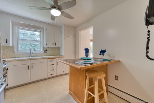 28 Clementel Dr, Durham, CT 06422 - kitchen featuring a baseboard radiator, light countertops, decorative backsplash, and white cabinets