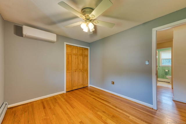 28 Clementel Dr, Durham, CT 06422 - unfurnished bedroom with a wall unit AC, light wood-type flooring, a closet, and a baseboard radiator