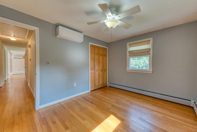 28 Clementel Dr, Durham, CT 06422 - unfurnished bedroom featuring a wall unit AC, a baseboard heating unit, light wood-style flooring, attic access, and an AC wall unit