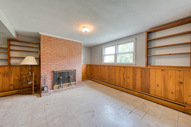 28 Clementel Dr, Durham, CT 06422 - unfurnished living room featuring a baseboard radiator, a wainscoted wall, wood walls, a textured ceiling, and a brick fireplace