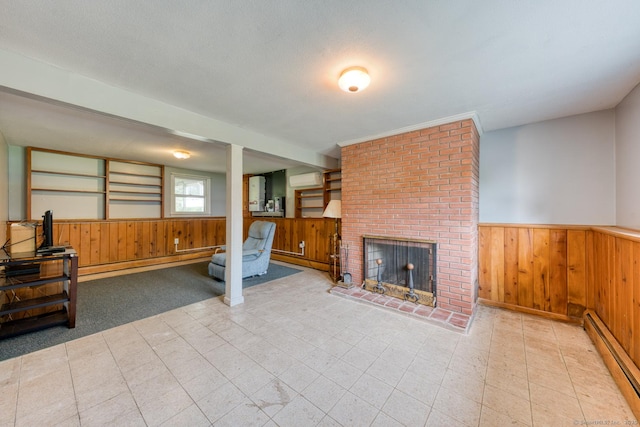 28 Clementel Dr, Durham, CT 06422 - unfurnished living room featuring baseboard heating, wainscoting, wooden walls, a fireplace, and a wall mounted AC