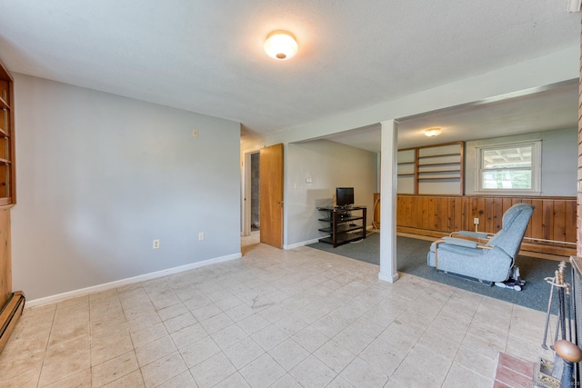 28 Clementel Dr, Durham, CT 06422 - living area featuring wooden walls, a wainscoted wall, and baseboard heating