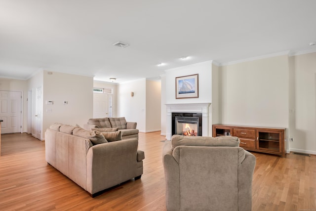 71 Lavender Ln Unit 71, South Windsor, CT 06074 - living area featuring ornamental molding, light wood-style flooring, and a glass covered fireplace