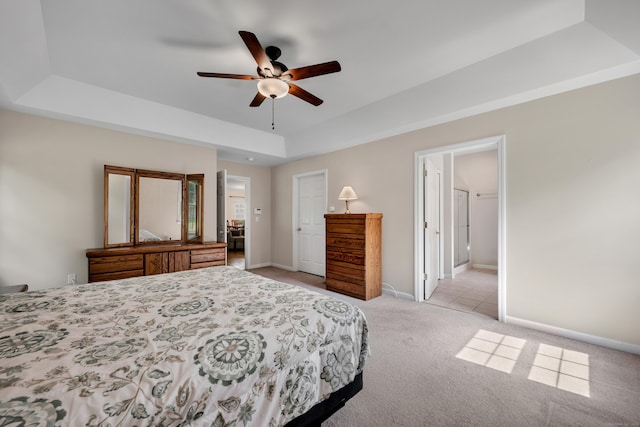 71 Lavender Ln Unit 71, South Windsor, CT 06074 - bedroom with a tray ceiling, light carpet, ceiling fan, and ensuite bath