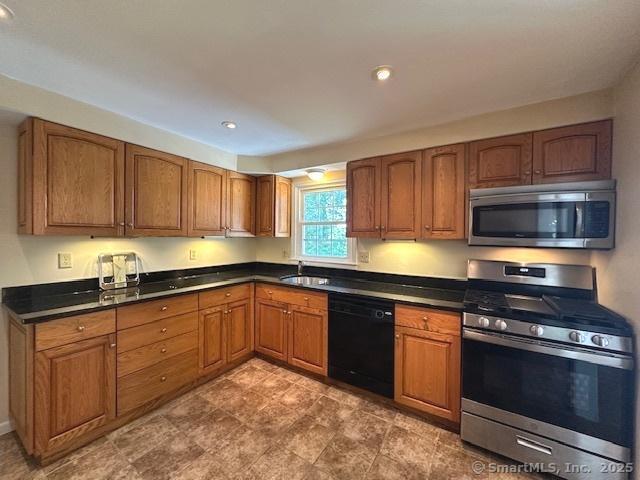 15 Bargate Rd, Clinton, CT 06413 - kitchen with stainless steel appliances, dark countertops, brown cabinetry, and recessed lighting