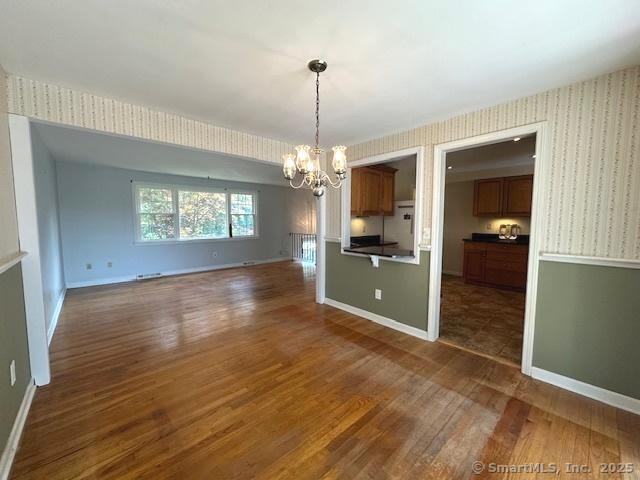 15 Bargate Rd, Clinton, CT 06413 - unfurnished dining area with a chandelier and dark wood finished floors