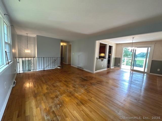 15 Bargate Rd, Clinton, CT 06413 - unfurnished living room featuring a chandelier and wood finished floors