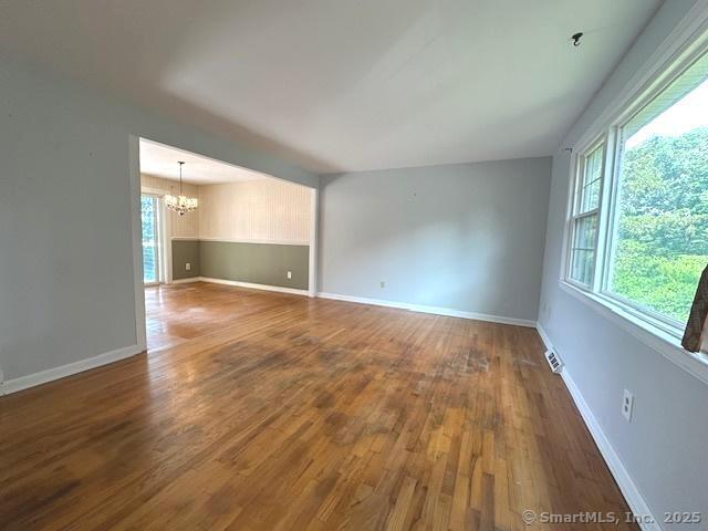 15 Bargate Rd, Clinton, CT 06413 - empty room with a chandelier and wood finished floors