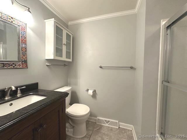 15 Bargate Rd, Clinton, CT 06413 - bathroom with ornamental molding, vanity, and a shower with shower door