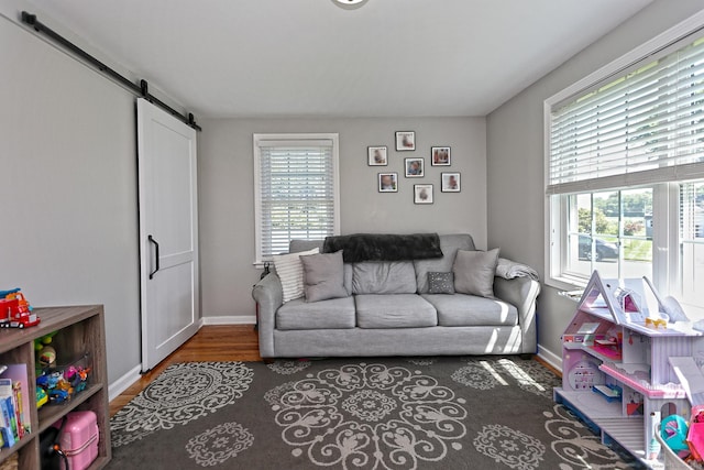 30 Wilcox Rd, Milford, CT 06460 - living area featuring a barn door and wood finished floors