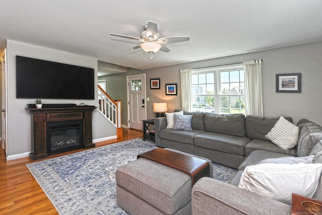 30 Wilcox Rd, Milford, CT 06460 - living room featuring stairs, a ceiling fan, wood finished floors, and a glass covered fireplace