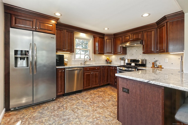 30 Wilcox Rd, Milford, CT 06460 - kitchen featuring stainless steel appliances, under cabinet range hood, a peninsula, light stone counters, and backsplash
