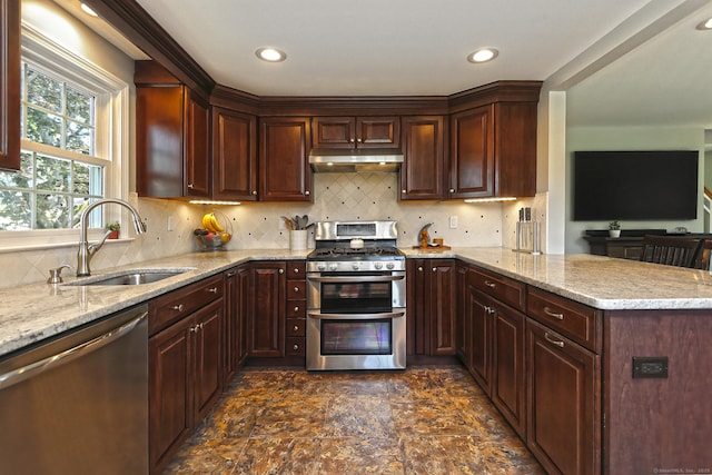 30 Wilcox Rd, Milford, CT 06460 - kitchen featuring appliances with stainless steel finishes, under cabinet range hood, a peninsula, light stone countertops, and recessed lighting