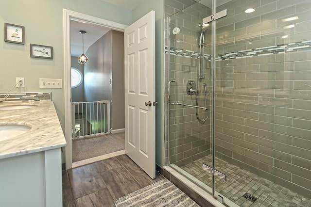 30 Wilcox Rd, Milford, CT 06460 - bathroom featuring wood finished floors, a stall shower, and double vanity