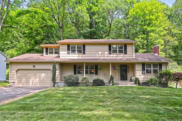 55 Gate Way, Hamden, CT 06518 - view of front of house with asphalt driveway, a garage, a chimney, a front lawn, and a porch