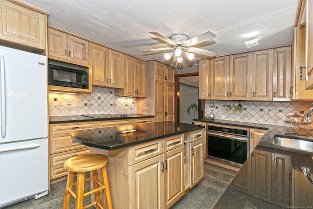 55 Gate Way, Hamden, CT 06518 - kitchen with freestanding refrigerator, stainless steel oven, black microwave, dark countertops, and a center island