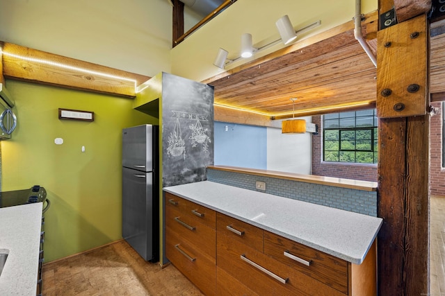 68 Thermos Ave Unit 302D, Norwich, CT 06360 - kitchen with freestanding refrigerator, brown cabinetry, and wooden ceiling