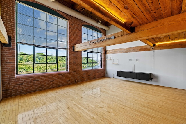 68 Thermos Ave Unit 302D, Norwich, CT 06360 - unfurnished living room with hardwood / wood-style floors, a wooden ceiling with exposed beams, and brick wall