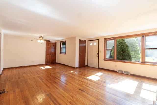 26 Hunt Ln, East Haven, CT 06512 - unfurnished living room with light wood-style floors and a ceiling fan