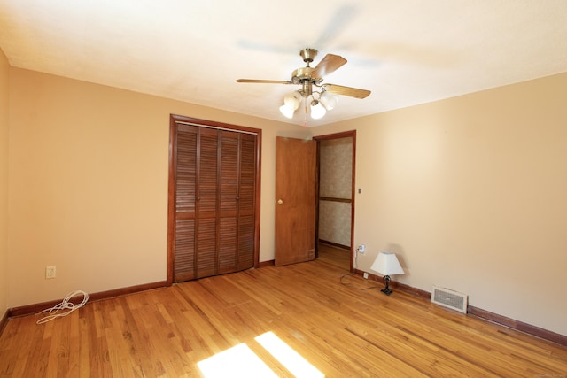26 Hunt Ln, East Haven, CT 06512 - unfurnished bedroom featuring a closet, light wood-style flooring, and a ceiling fan