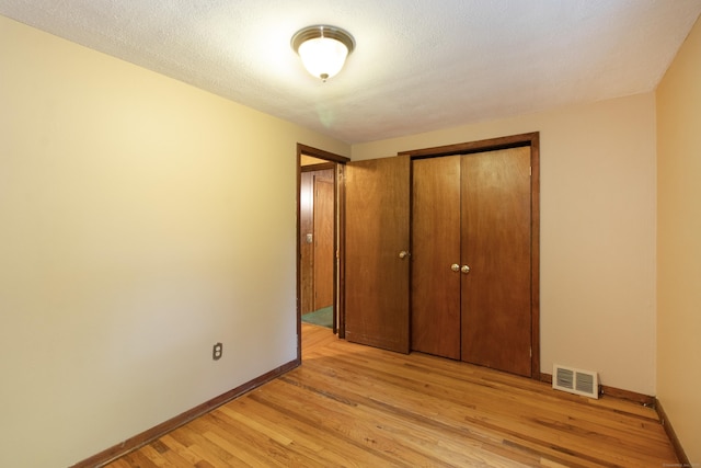 26 Hunt Ln, East Haven, CT 06512 - unfurnished bedroom featuring light wood-style flooring and a closet