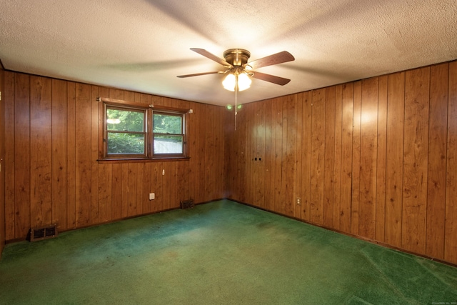 26 Hunt Ln, East Haven, CT 06512 - carpeted spare room featuring a ceiling fan, a textured ceiling, and wood walls