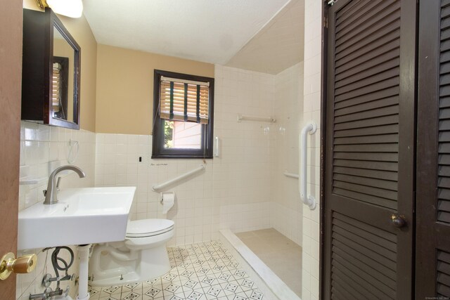 26 Hunt Ln, East Haven, CT 06512 - full bath with a shower stall, a closet, tile patterned flooring, tile walls, and wainscoting