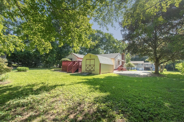 26 Hunt Ln, East Haven, CT 06512 - view of grassy yard with a storage shed, a wooden deck, stairway, and view of wooded area