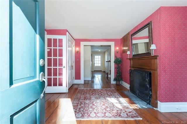 300 Ridgefield Rd, Wilton, CT 06897 - foyer with wood-type flooring, wallpapered walls, and a fireplace with flush hearth