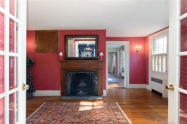 300 Ridgefield Rd, Wilton, CT 06897 - entryway featuring radiator, wallpapered walls, wood-type flooring, and a large fireplace