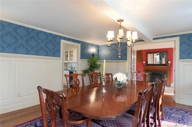 300 Ridgefield Rd, Wilton, CT 06897 - dining area with a chandelier, wallpapered walls, wood finished floors, a decorative wall, and wainscoting