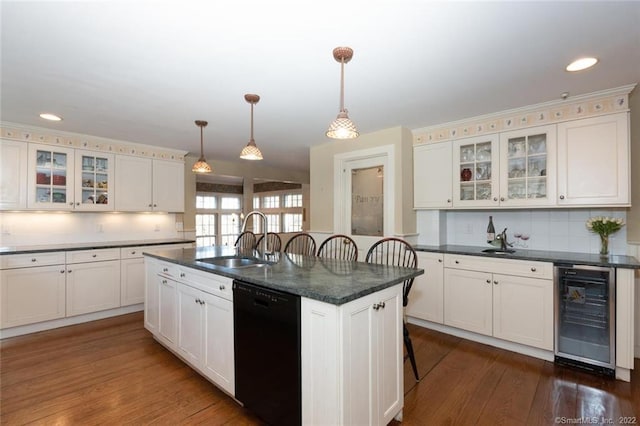 300 Ridgefield Rd, Wilton, CT 06897 - kitchen featuring black dishwasher, beverage cooler, a kitchen breakfast bar, tasteful backsplash, and dark wood-style floors