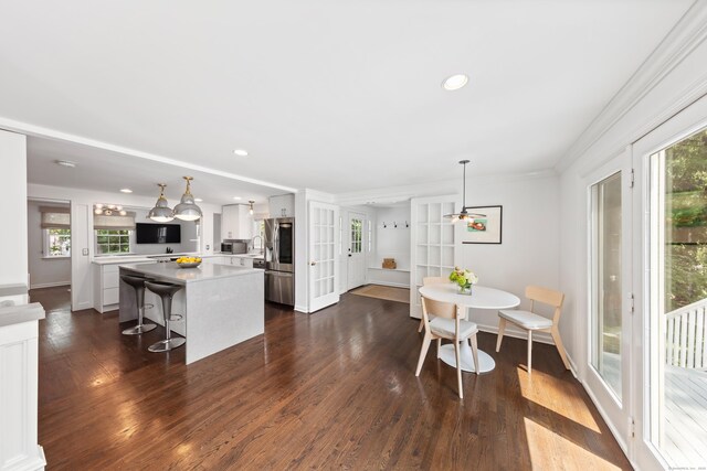 28 Great Hill Rd, Darien, CT 06820 - kitchen with light countertops, dark wood-style floors, a kitchen island, stainless steel appliances, and plenty of natural light