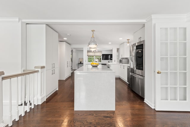 28 Great Hill Rd, Darien, CT 06820 - kitchen featuring appliances with stainless steel finishes, a center island, dark wood finished floors, white cabinets, and light countertops