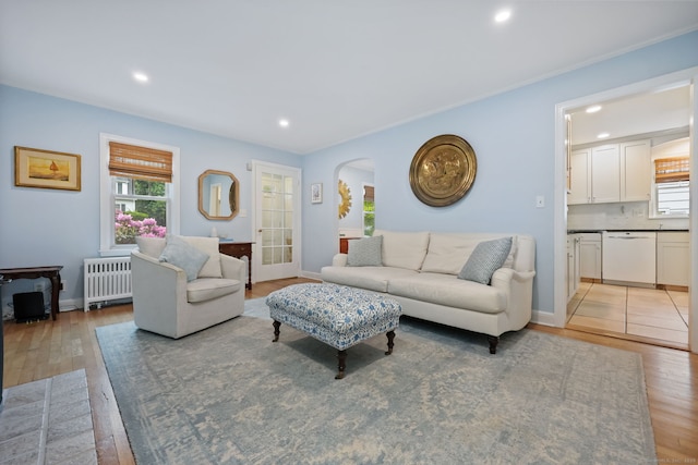 161 Crestwood Rd, Fairfield, CT 06824 - living area with radiator, plenty of natural light, light wood finished floors, arched walkways, and recessed lighting