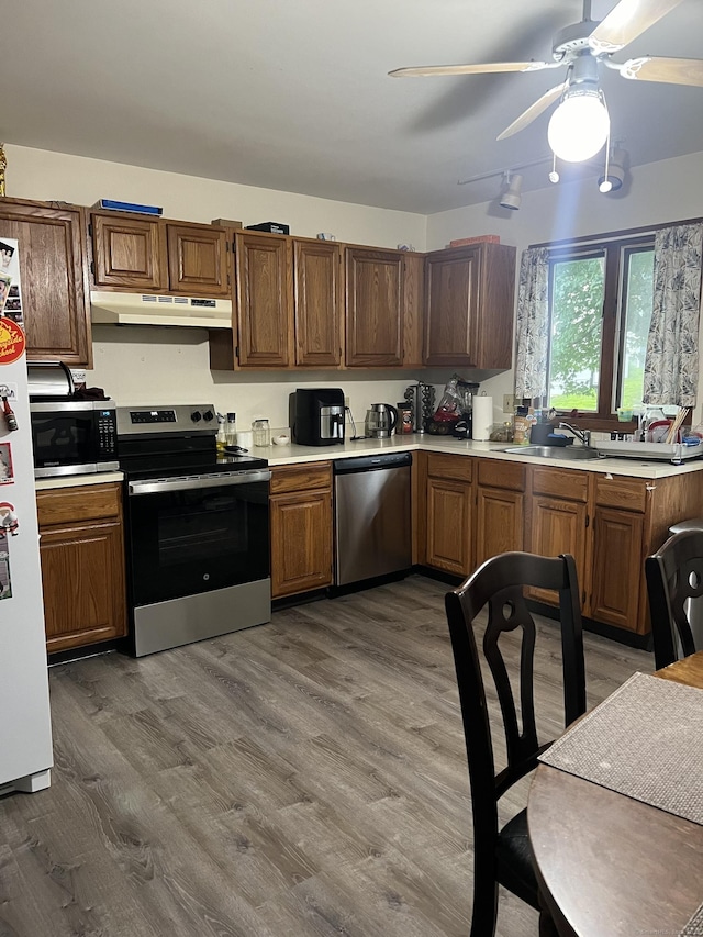 58 Milne Ave, Shelton, CT 06484 - kitchen with stainless steel appliances, under cabinet range hood, light countertops, wood finished floors, and ceiling fan