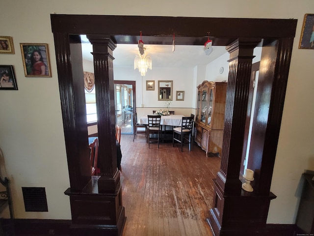 73 Newfield Ave, Bridgeport, CT 06607 - corridor with decorative columns, hardwood / wood-style flooring, and a chandelier