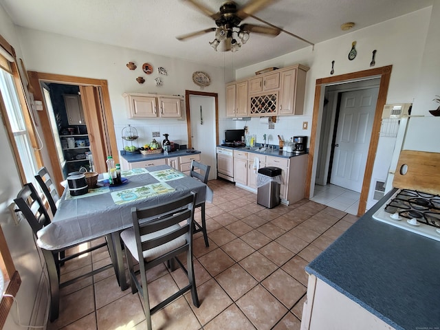 73 Newfield Ave, Bridgeport, CT 06607 - kitchen with ceiling fan, backsplash, dark countertops, white gas cooktop, and cream cabinetry
